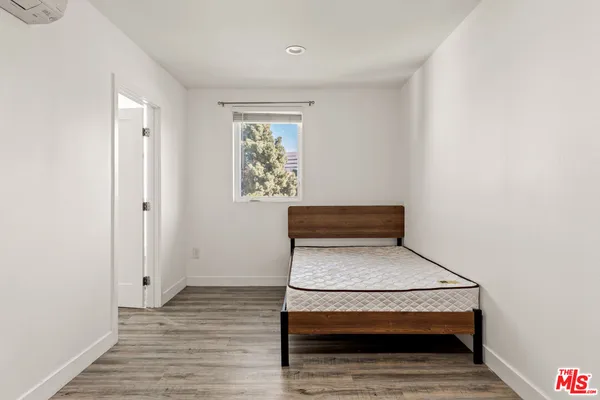 a view of a room with wooden floor and furniture