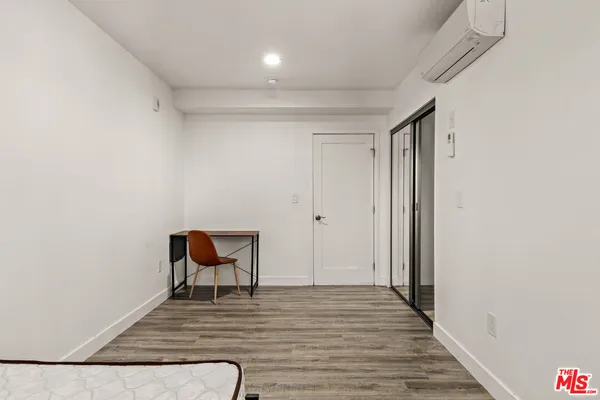 a view of room with wooden floor and closet