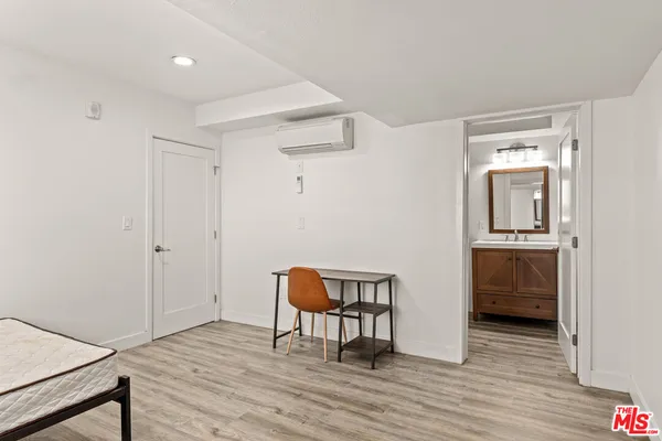 a view of room with furniture and wooden floor