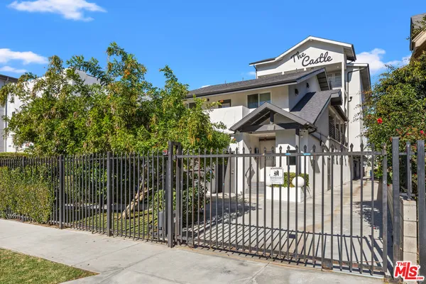 a front view of a house with a iron gate