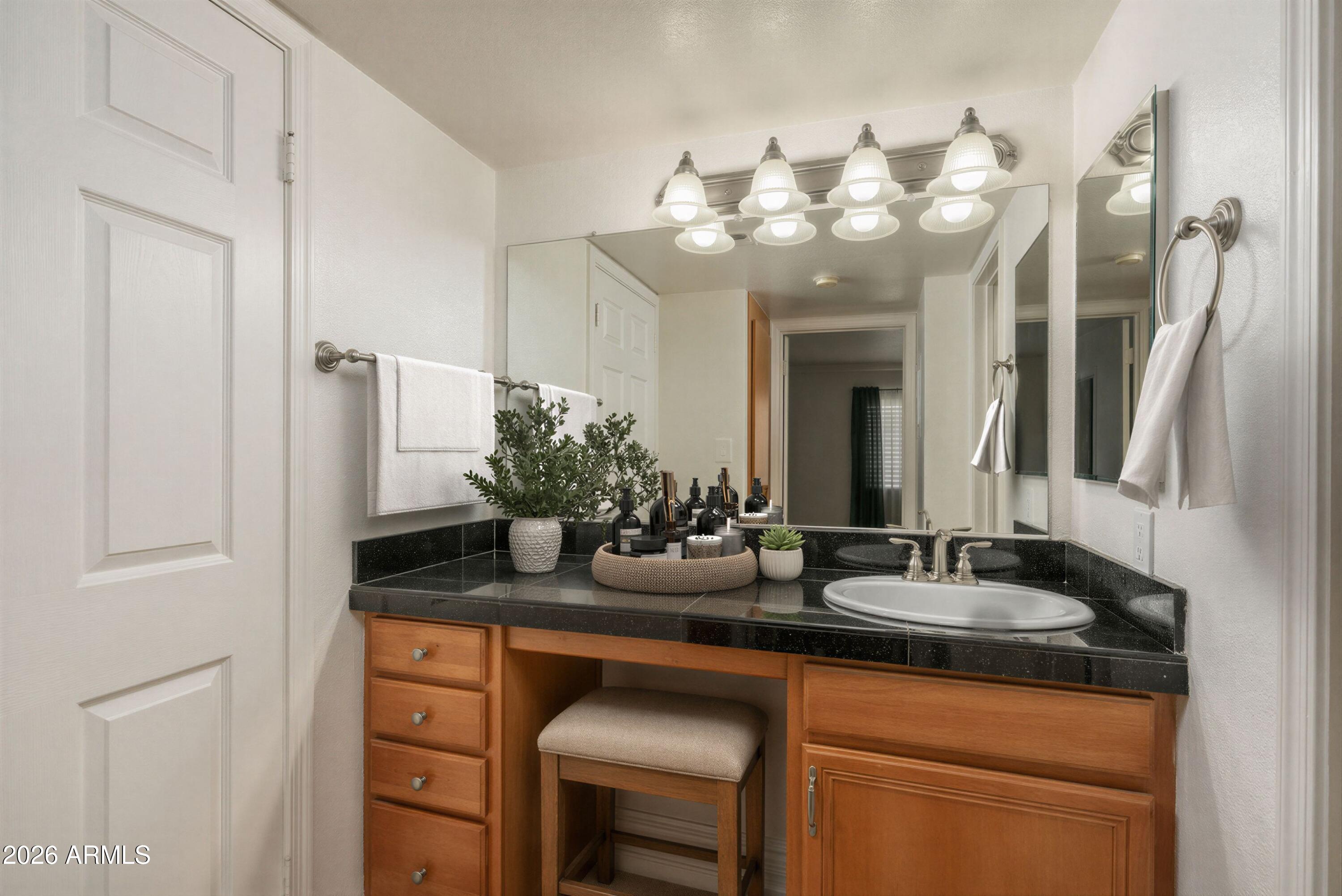 3825 East Camelback Road, Unit 269 Phoenix, AZ 85018 - Photo 12 of 25 a bathroom with a sink and a mirror