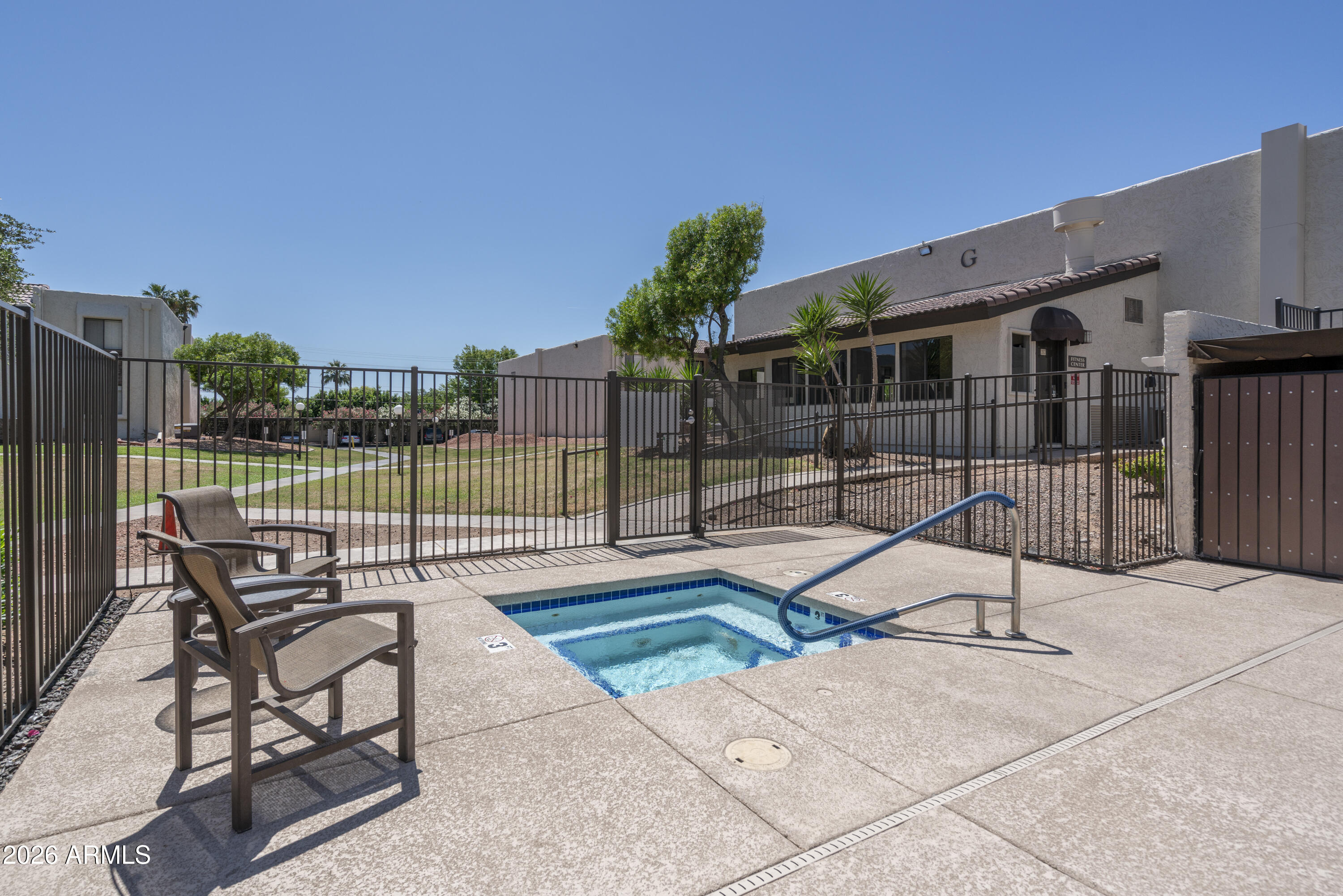 3825 East Camelback Road, Unit 269 Phoenix, AZ 85018 - Photo 21 of 25 a view of a chair and tables in the patio