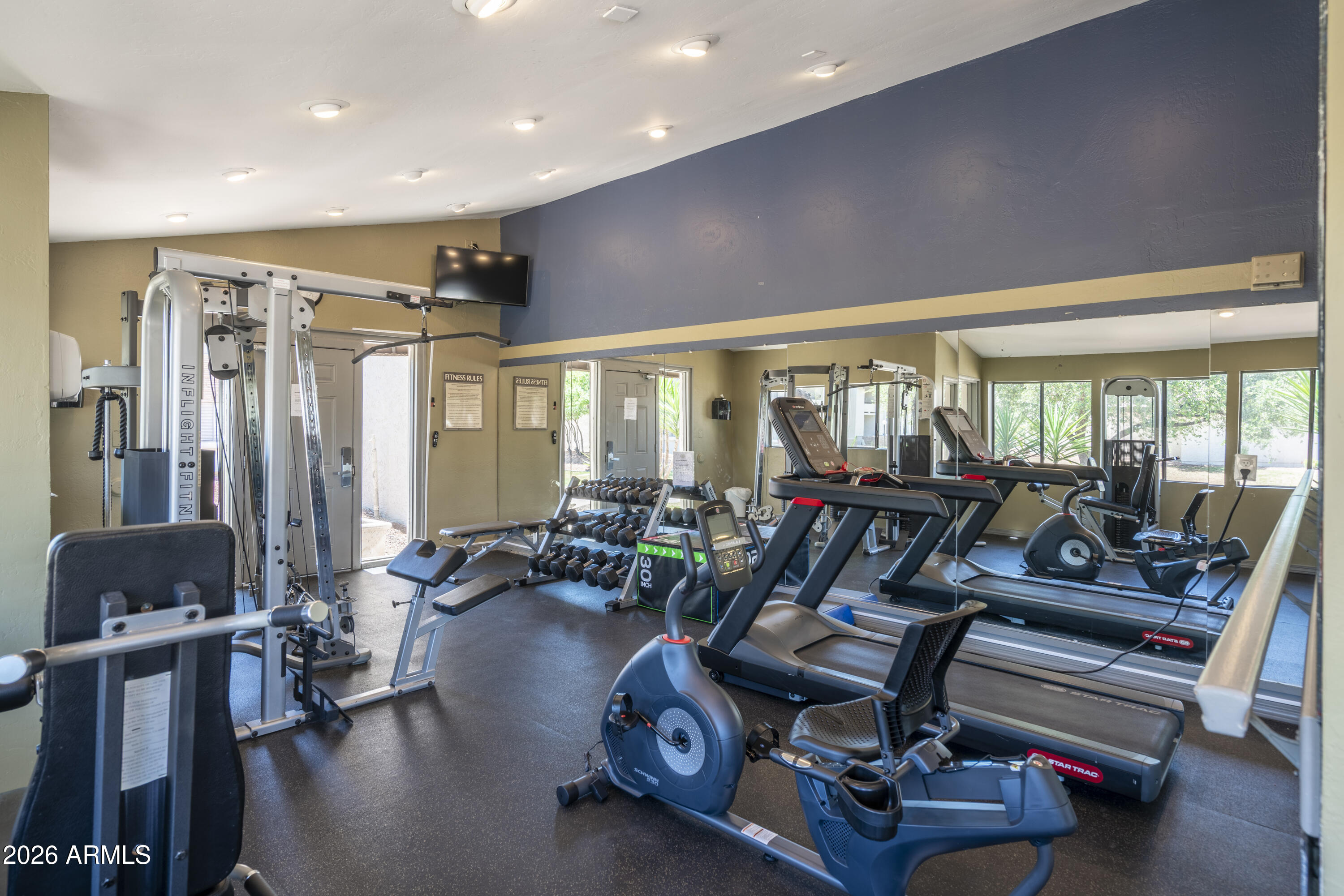 3825 East Camelback Road, Unit 269 Phoenix, AZ 85018 - Photo 22 of 25 a living room with furniture gym equipment and a large window