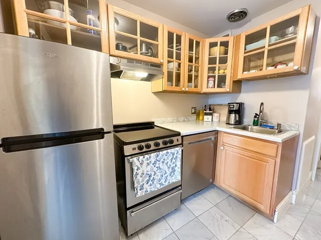 a kitchen with stainless steel appliances a refrigerator sink and cabinets