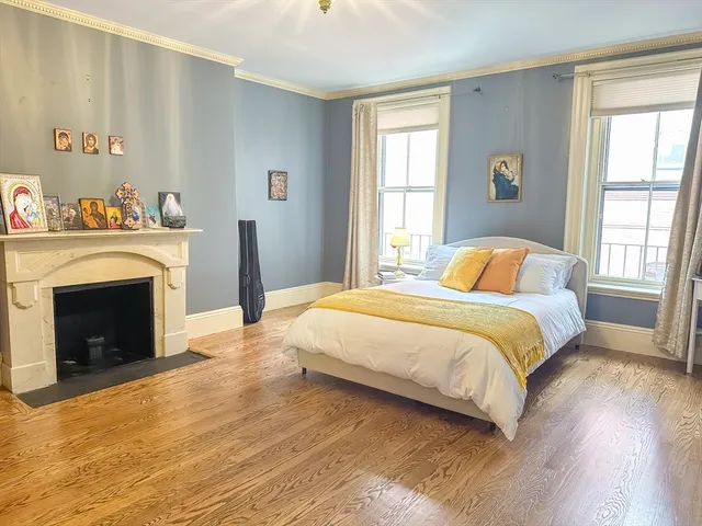 a bedroom with a bed and a fireplace