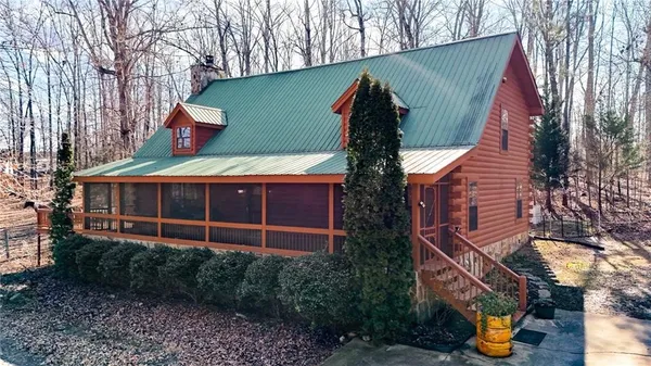 a view of a brick house with a small yard