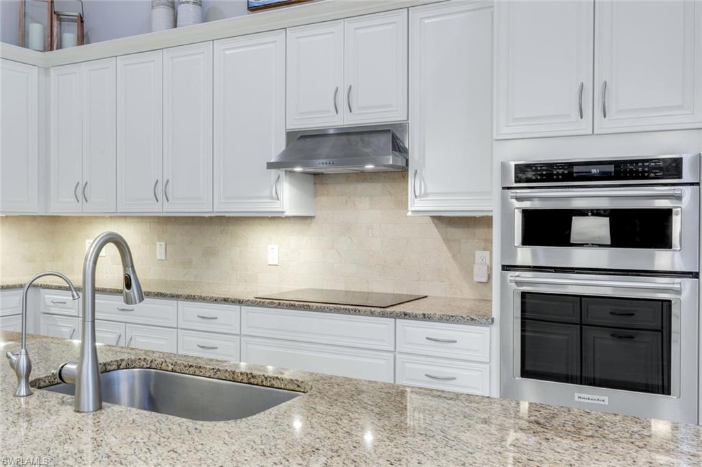 9282 Quarry Drive Naples, FL 34120 - Photo 12 of 50 a kitchen with granite countertop a sink and a stove