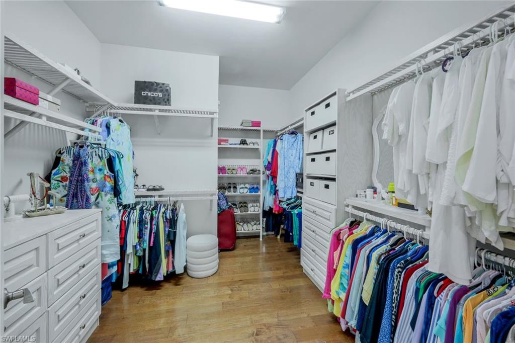 9282 Quarry Drive Naples, FL 34120 - Photo 18 of 50 a view of walk in closet with clothes
