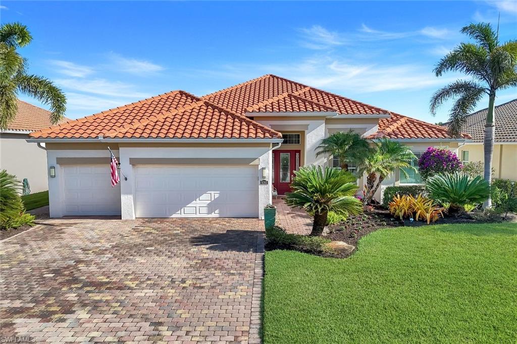 9282 Quarry Drive Naples, FL 34120 - Photo 2 of 50 a front view of a house with a garden