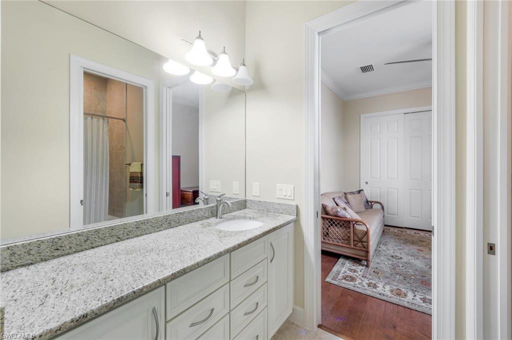 9282 Quarry Drive Naples, FL 34120 - Photo 25 of 50 a bathroom with a granite countertop sink and a mirror