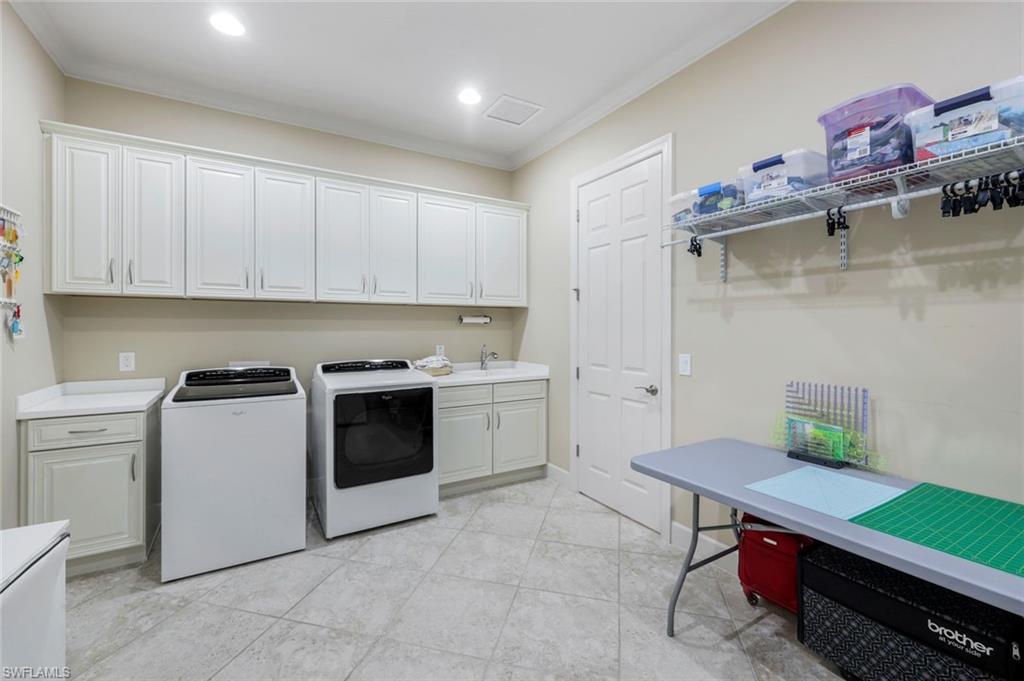 9282 Quarry Drive Naples, FL 34120 - Photo 28 of 50 a kitchen with a stove a sink and cabinets