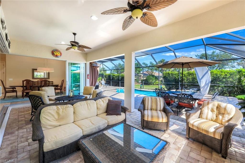 9282 Quarry Drive Naples, FL 34120 - Photo 31 of 50 a living room with furniture and a large window
