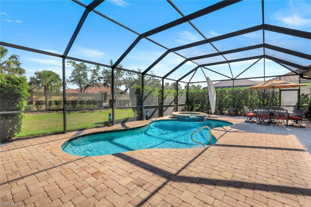 9282 Quarry Drive Naples, FL 34120 - Photo 32 of 50 a view of a swimming pool with a patio