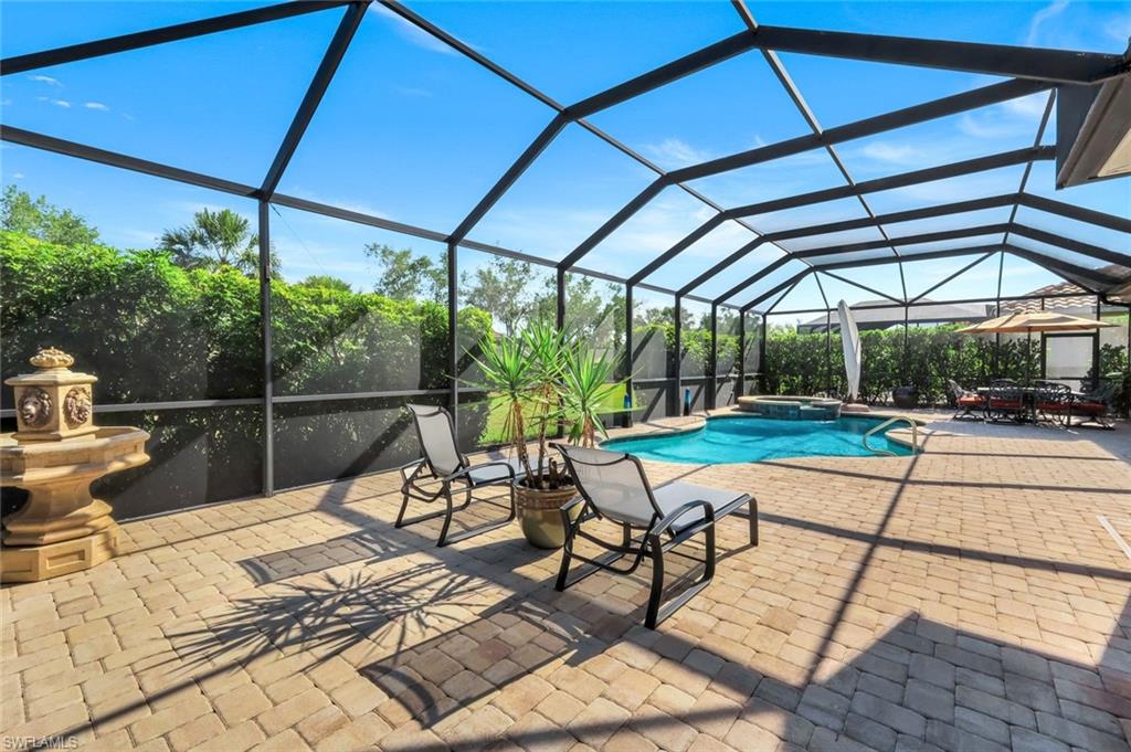 9282 Quarry Drive Naples, FL 34120 - Photo 34 of 50 a view of a swimming pool with a patio