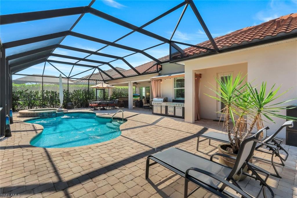 9282 Quarry Drive Naples, FL 34120 - Photo 36 of 50 a view of a backyard with plants and a patio