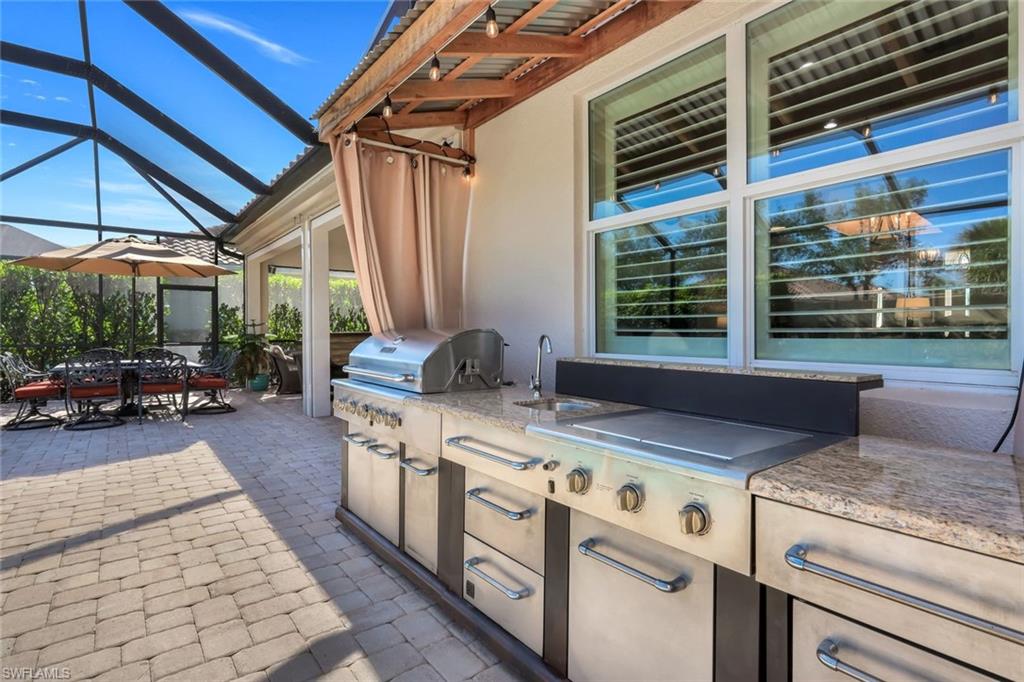 9282 Quarry Drive Naples, FL 34120 - Photo 37 of 50 a view of a kitchen with a sink and furniture