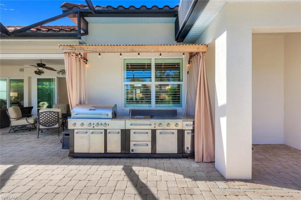 9282 Quarry Drive Naples, FL 34120 - Photo 38 of 50 a view of a kitchen with a stove