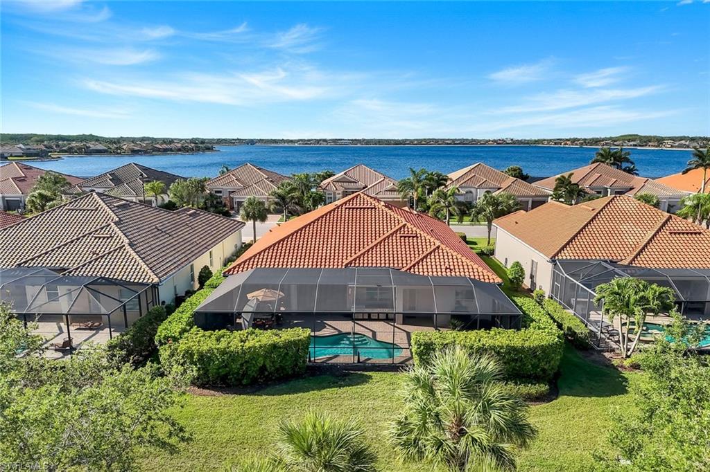 9282 Quarry Drive Naples, FL 34120 - Photo 41 of 50 an aerial view of a house with a yard and lake view