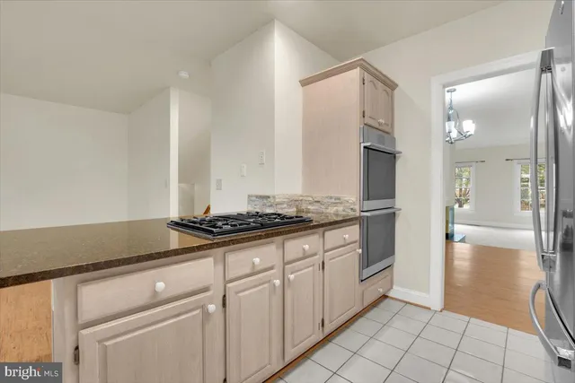 a kitchen with granite countertop a sink and a stove top oven