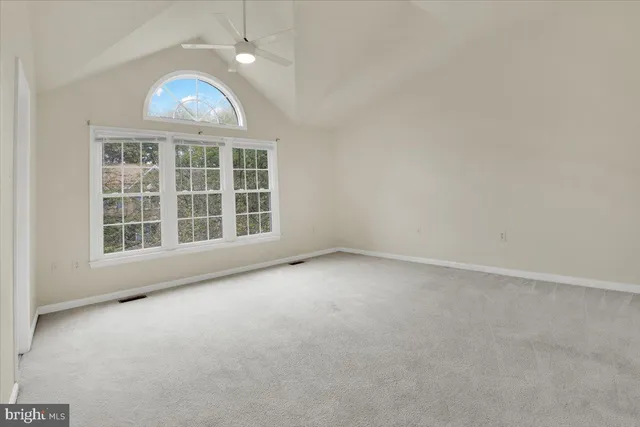 an empty room with a empty space and windows