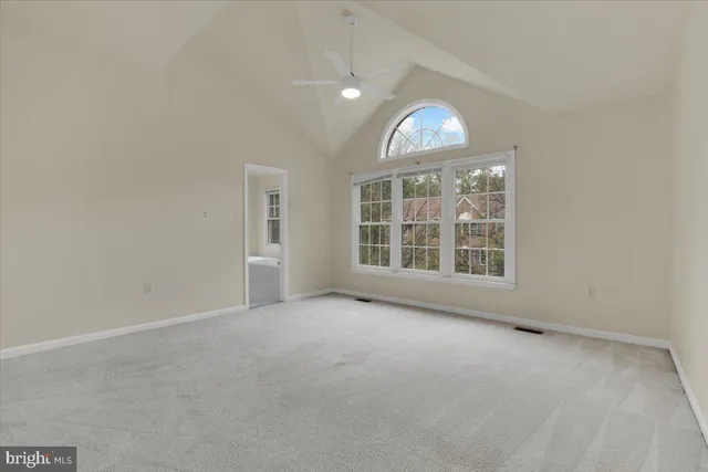 an empty room with a empty space and windows