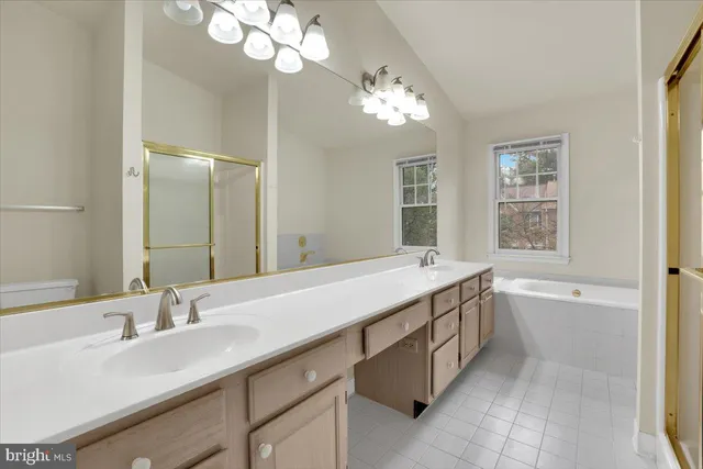 a bathroom with a granite countertop sink a large mirror and a bathtub with shower