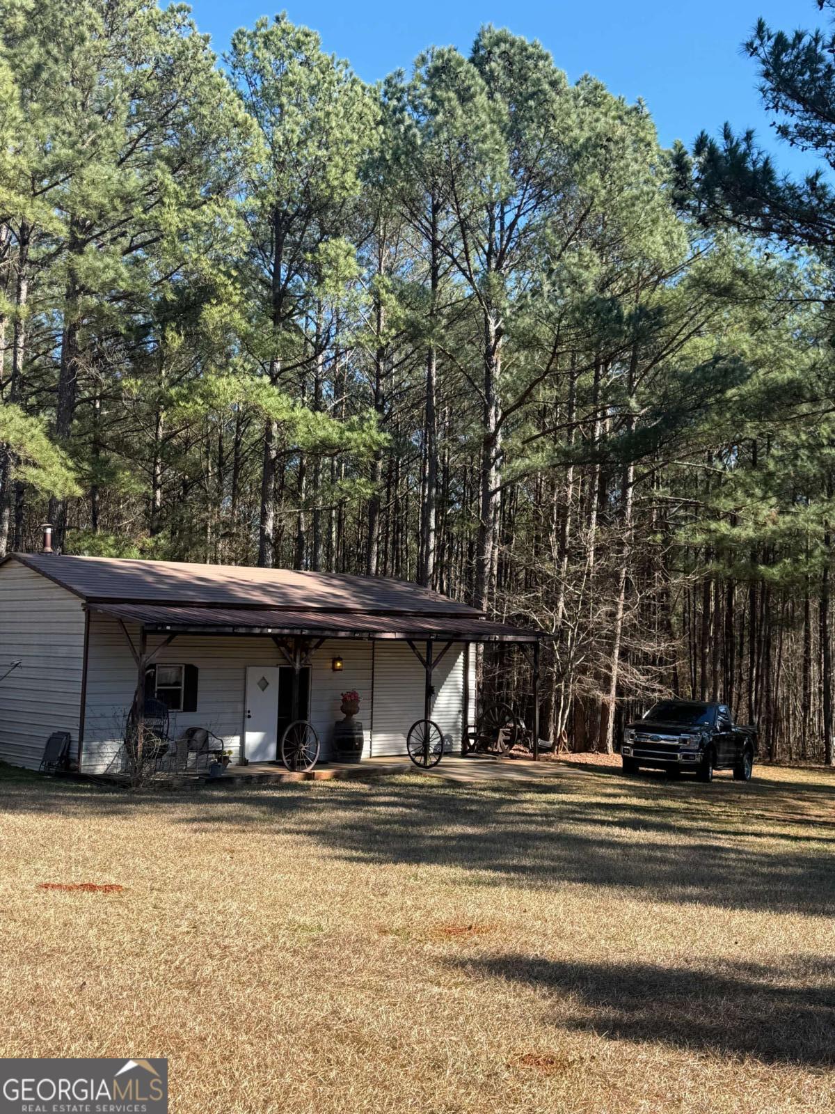 670 Jefferies Road Shady Dale, GA 31085 - Photo 11 of 29 a view of house with outdoor space and swimming pool