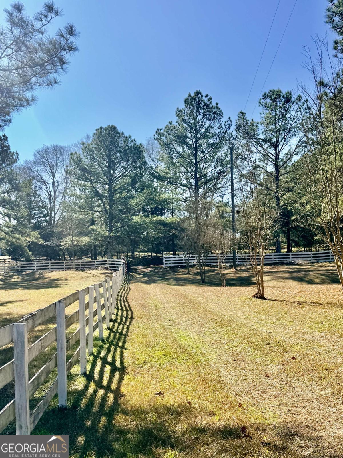 670 Jefferies Road Shady Dale, GA 31085 - Photo 4 of 29 a swimming pool with an outdoor space and seating area