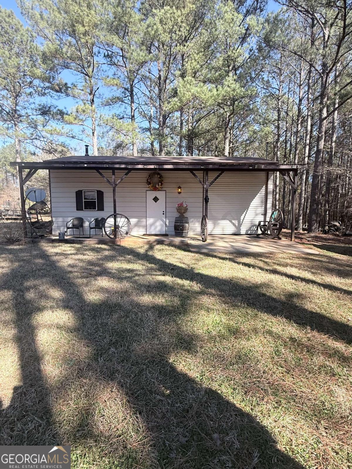 670 Jefferies Road Shady Dale, GA 31085 - Photo 10 of 29 a view of a house with a forest