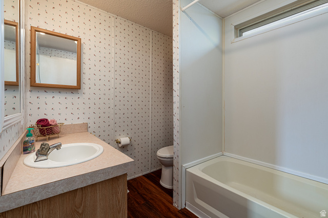 740 Riddle Drive Fredonia, AZ 86022 - Photo 6 of 20 Bathroom featuring a single vanity with integrated sink, wood-finish cabinetry, and a framed mirror