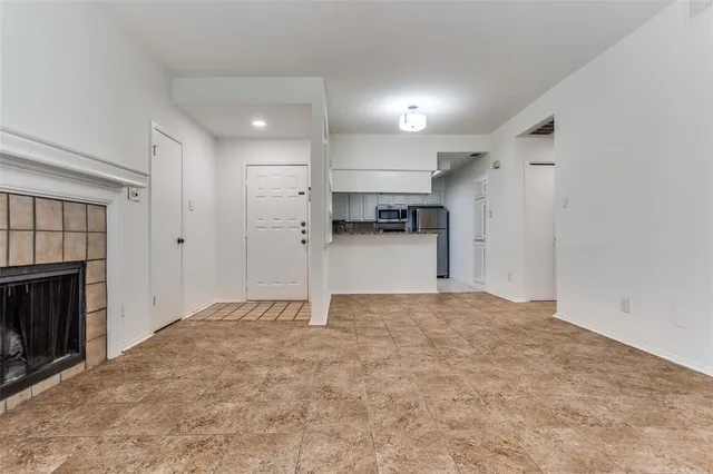 a view of an empty room and a fireplace
