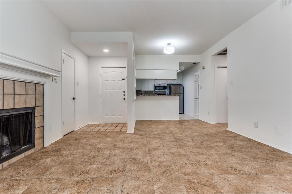 3110 Devonshire Drive, Unit 117 Plano, TX 75075 - Photo 2 of 13 a view of an empty room and a fireplace