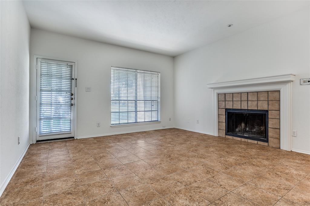 3110 Devonshire Drive, Unit 117 Plano, TX 75075 - Photo 3 of 13 an empty room with windows and fireplace