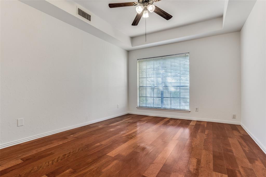 3110 Devonshire Drive, Unit 117 Plano, TX 75075 - Photo 7 of 13 a view of an empty room with wooden floor and a window