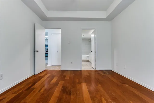 a view of a room with wooden floor