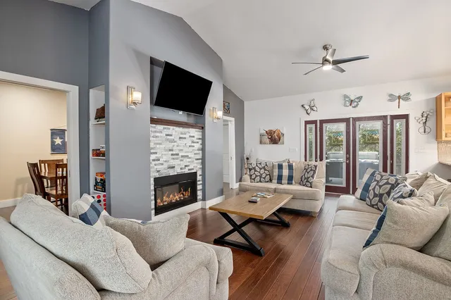 a living room with furniture fireplace and a flat screen tv