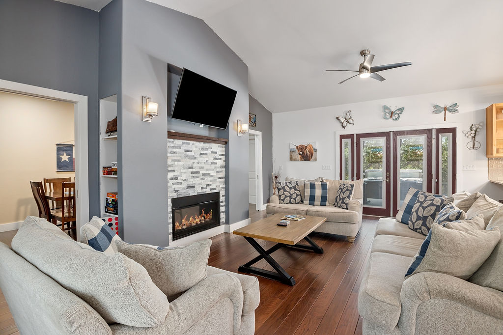 13326 Trautwein Road Austin, TX 78737 - Photo 11 of 40 a living room with furniture fireplace and a flat screen tv