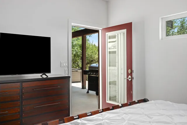 a bedroom with a bed and a flat screen tv
