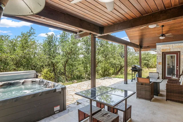 a view of a patio with table and chairs and potted plants