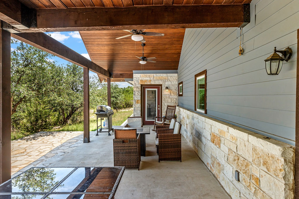 13326 Trautwein Road Austin, TX 78737 - Photo 30 of 40 a view of a porch with furniture and a yard