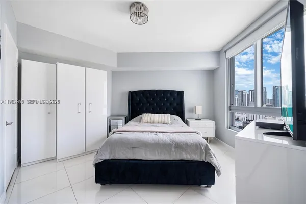 a bedroom with a bed and flat screen tv
