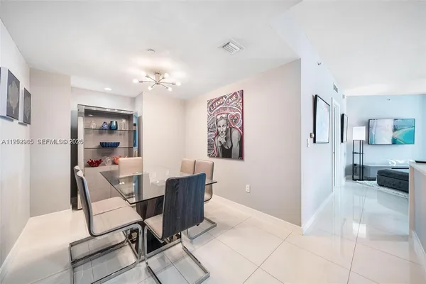 a view of a livingroom with furniture and a flat screen tv