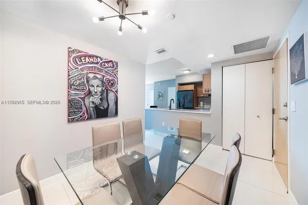 a living room with furniture and view of kitchen