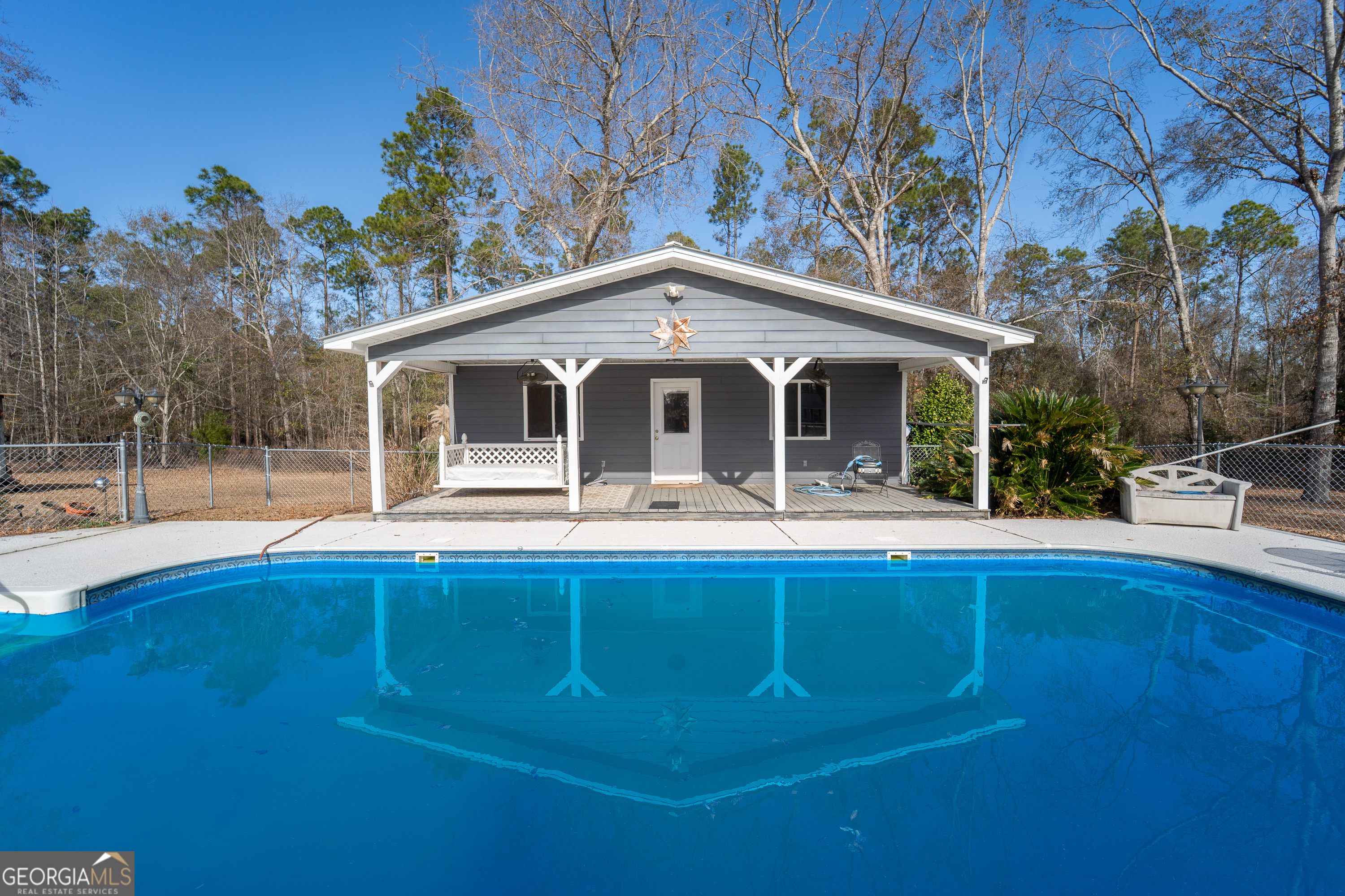 134 Patrick Street Swainsboro, GA 30401 - Photo 14 of 57 a front view of a house with swimming pool