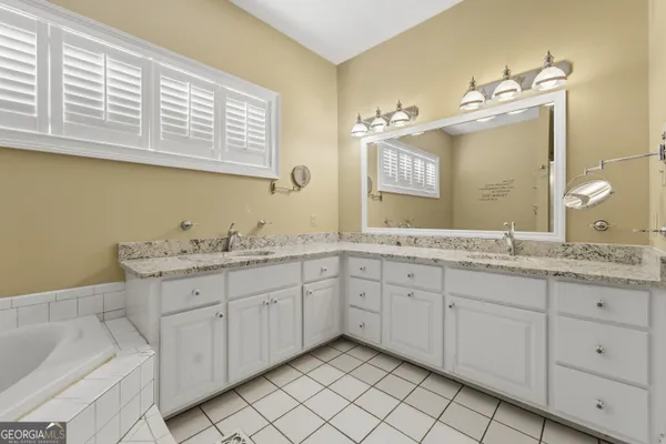 a bathroom with a double vanity sink and a mirror