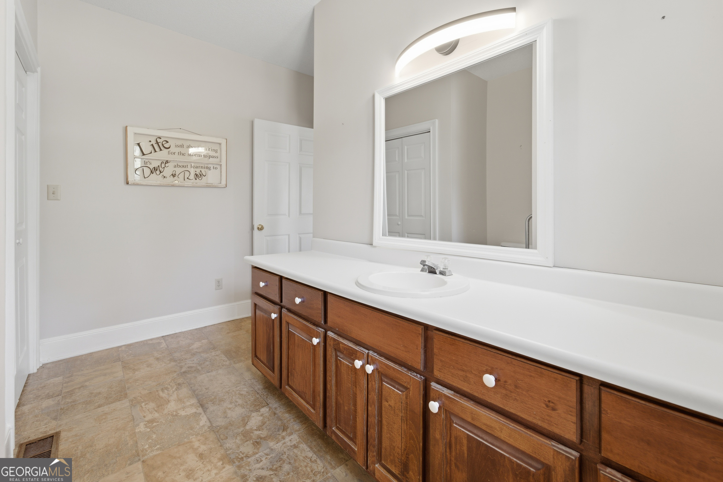 134 Patrick Street Swainsboro, GA 30401 - Photo 34 of 57 a bathroom with a double vanity sink and a mirror