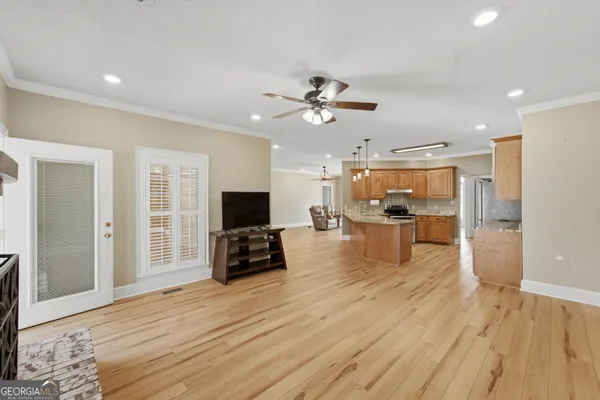 a kitchen with granite countertop a refrigerator stove and cabinets