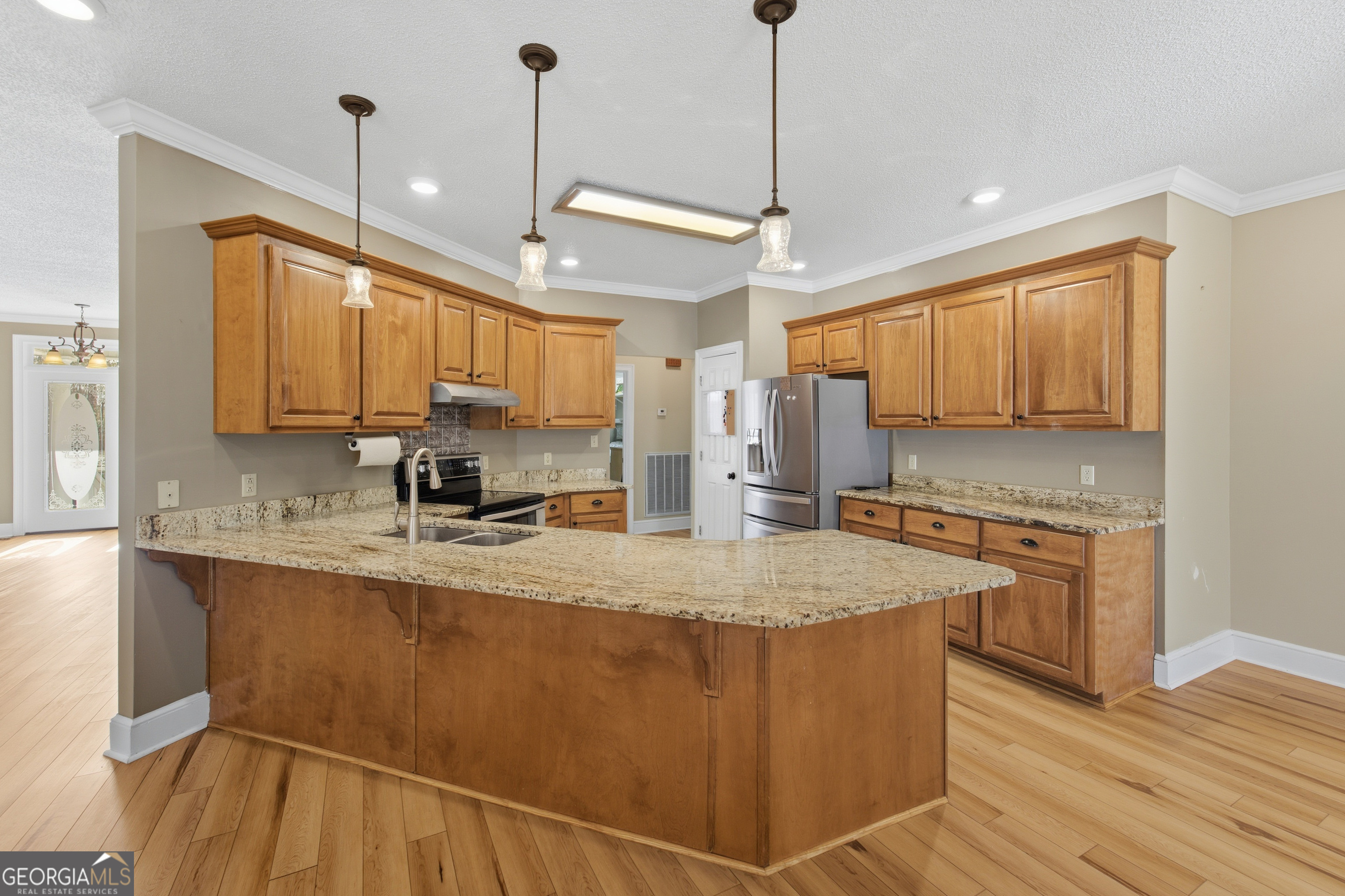134 Patrick Street Swainsboro, GA 30401 - Photo 38 of 57 a kitchen with stainless steel appliances granite countertop a sink a refrigerator and a stove