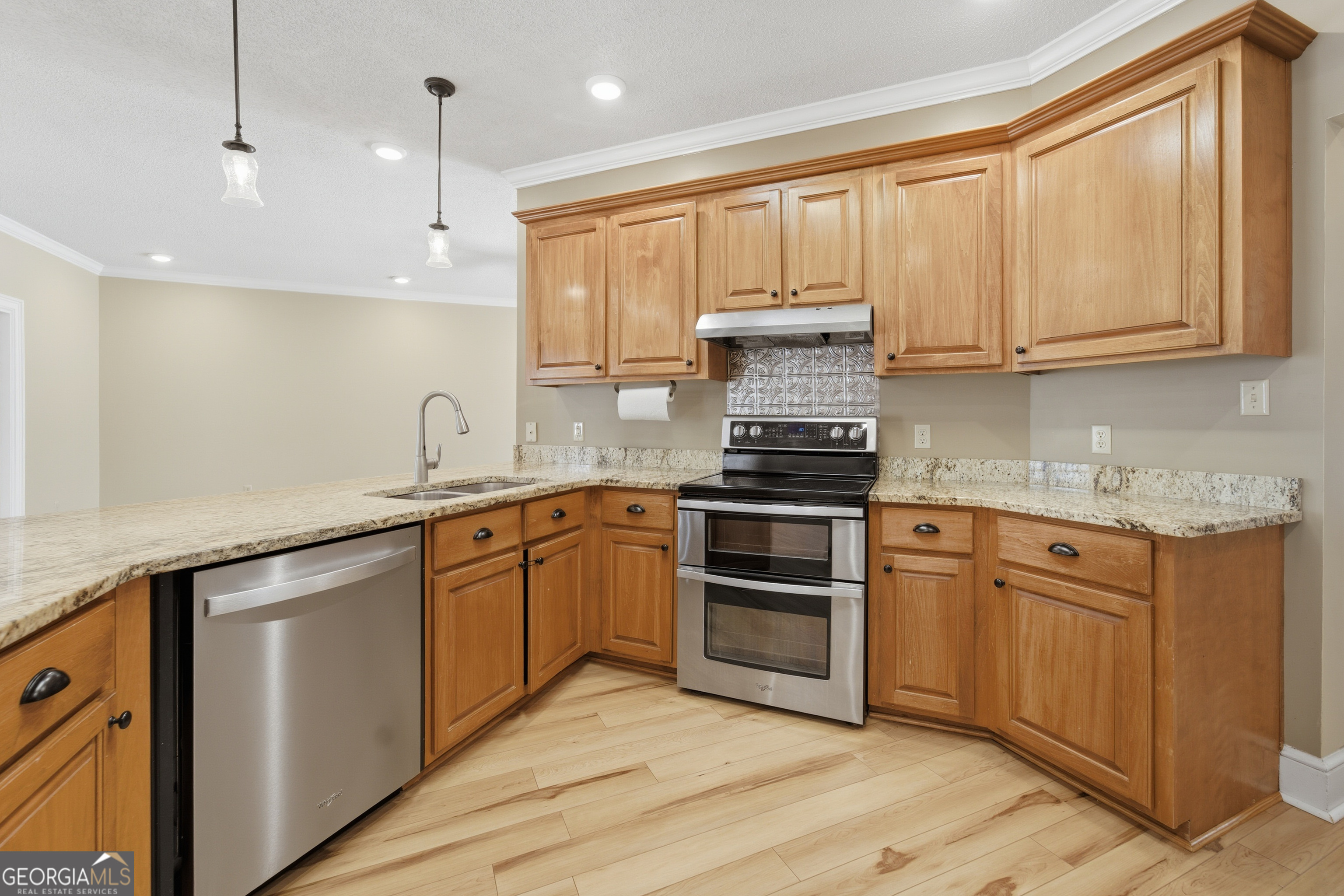 134 Patrick Street Swainsboro, GA 30401 - Photo 39 of 57 a kitchen with granite countertop cabinets stainless steel appliances a sink and a window