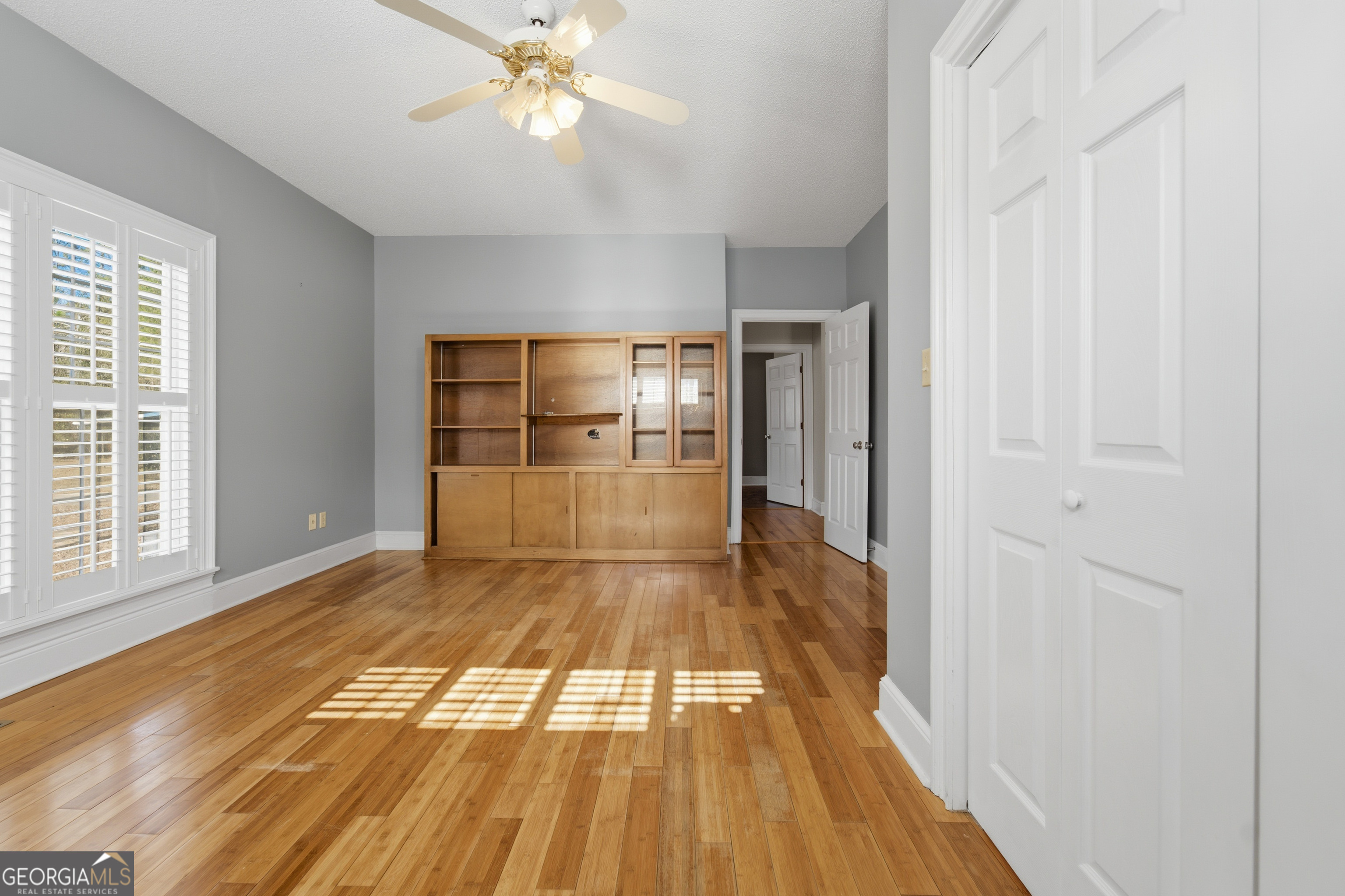 134 Patrick Street Swainsboro, GA 30401 - Photo 48 of 57 a view of empty room with wooden floor and fan
